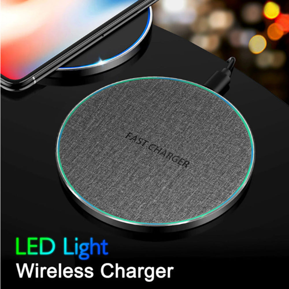 "Circular wireless charger with built-in LED light on dark surface, high-tech minimalist gadget for nightstand charging."
