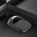 "High-end black digital accessory with reflective glass surface, professional product photography on a dark abstract geometric background."